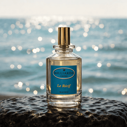 Le Récif perfume bottle on liquid stone surface with aquatic marine background