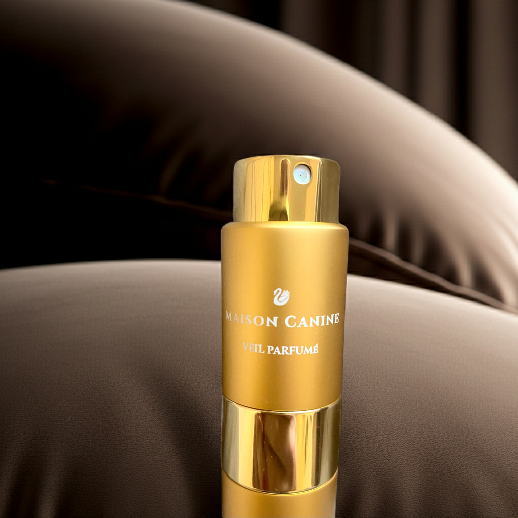 Maison Canine Veil Parfumé Mini gold dog fragrance bottle logo on dark brown cushion