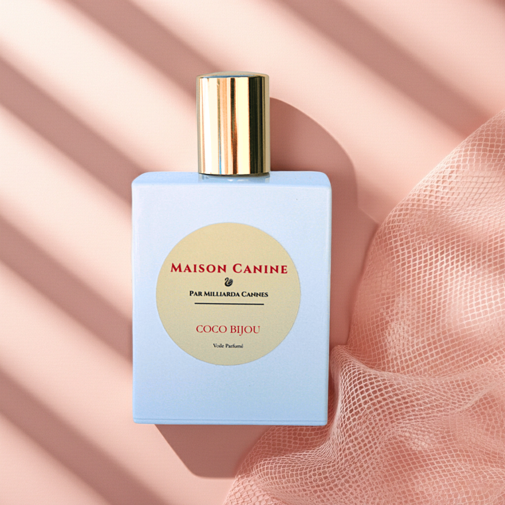 Maison Canine Coco Bijou veil parfumé dog mist in white perfume bottle with gold cap on a pink background