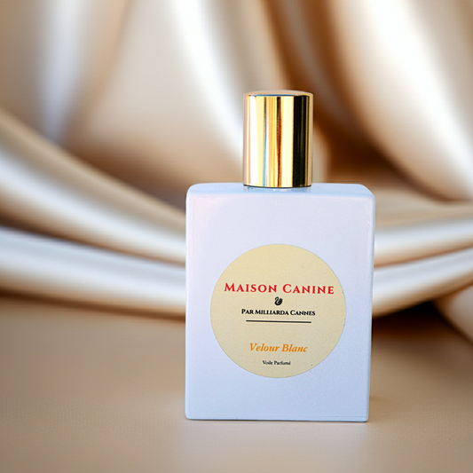 Maison Canine veil perfumé dog mist Velour Blanc in white perfume bottle with gold cap on a draped fabric background